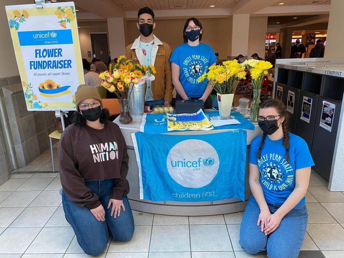 Members of Penn State UNICEF pose in front of their “Flower Fundraiser” booth at the HUB on Wednesday. The group is selling flowers Wednesday and Thursday to help raise money toward humanitarian aid in Ukraine. Members in the photo include, from top left, Juan Valdez and Sylvia Klimachefsky and, from bottom left, Jolene Werr and Julija Paskevicius.