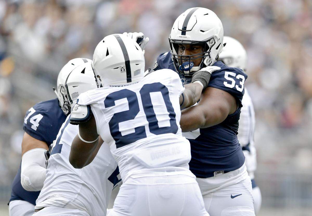 Penn State offensive lineman Rasheed Walker blocks defensive end Adisa Isaac during the Blue-White game on Saturday, April 13, 2019.