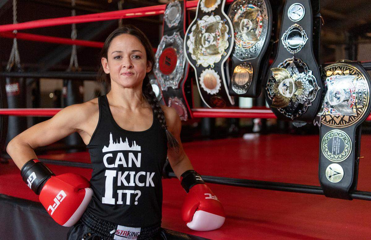 Elise Pone surrounded by some of her Muay Thai belts at Central PA Mixed Martial Arts on Thursday, July 7, 2022.