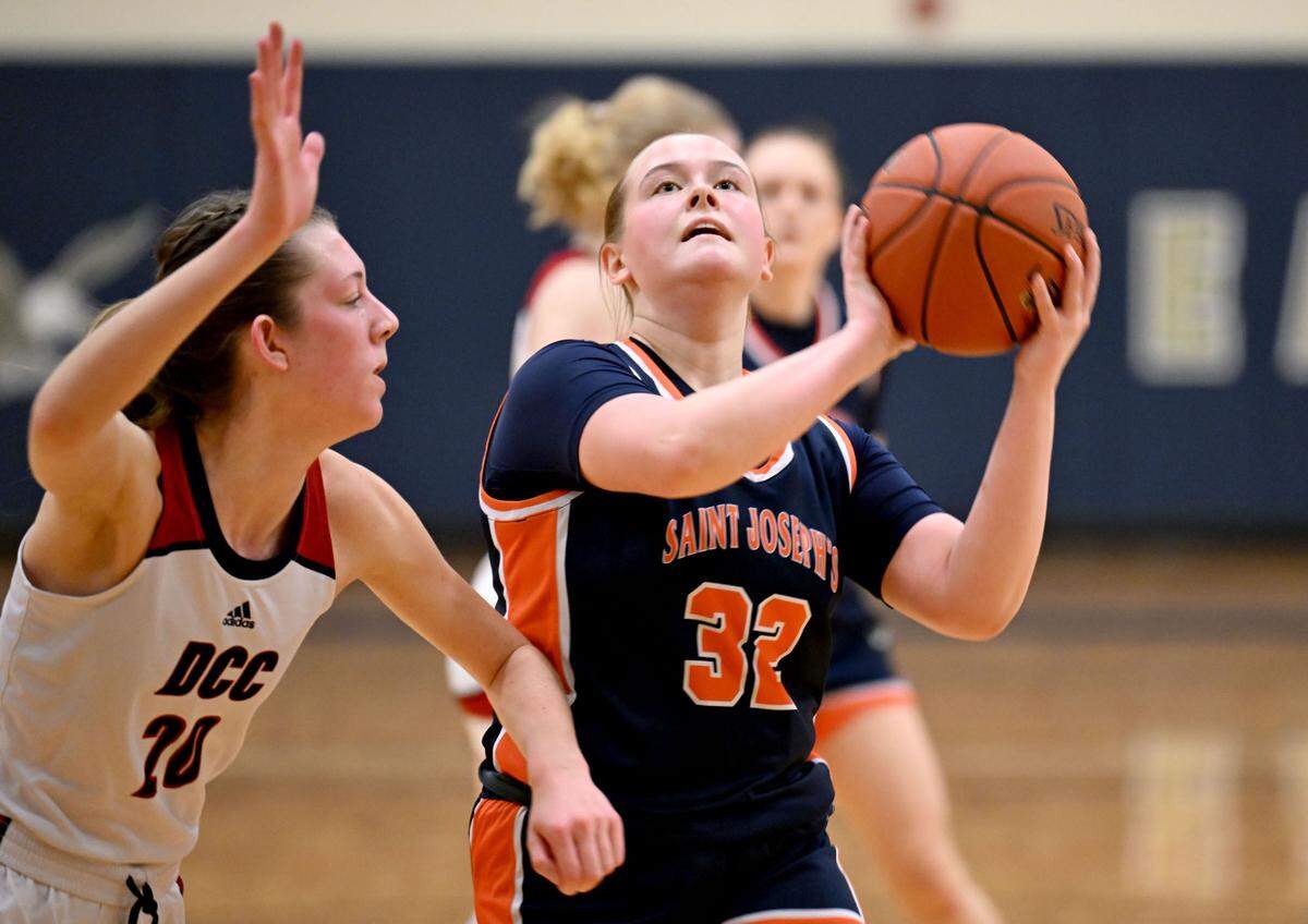 Saint Joseph’s Catholic Academy’s Lauren Himes goes in for a basket around DuBois Central Catholic’s Ella Elensky during the game on Wednesday, March, 12, 2025 at Bald Eagle Area High School.