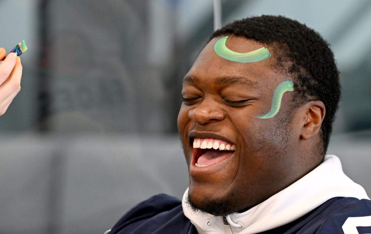 Penn State offensive lineman Anthony Donkoh laughs as he has his face painted during the Thon Explorers event on Saturday, Feb. 21, 2026 in the Lasch Building. 