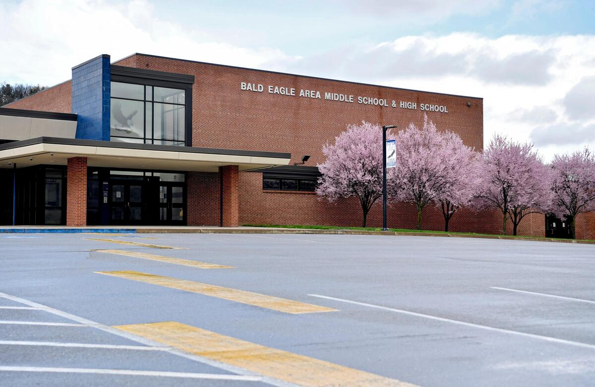Trees blossom in front of the Bald Eagle Area middle school and high school building as it sits empty on Thursday, April 9, 2020. Pa. governor Tom Wolf announced school will remain closed through the academic year.