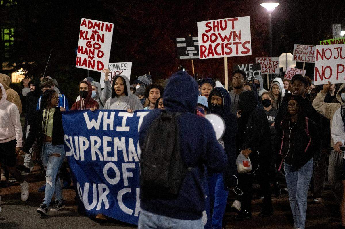 Protesters march down Pollock Road after the event “Stand Back & Stand By” was canceled on the Penn State campus on Monday, Oct. 24, 2022.