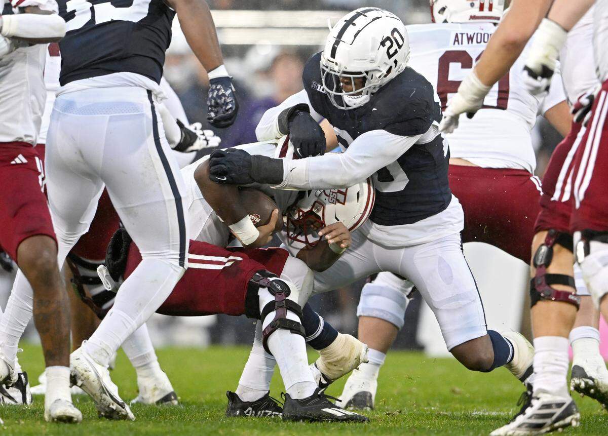 Penn State defensive end Adisa Isaac stops UMass quarterback Taisun Phommachanh during the game on Saturday, Oct. 14, 2023.