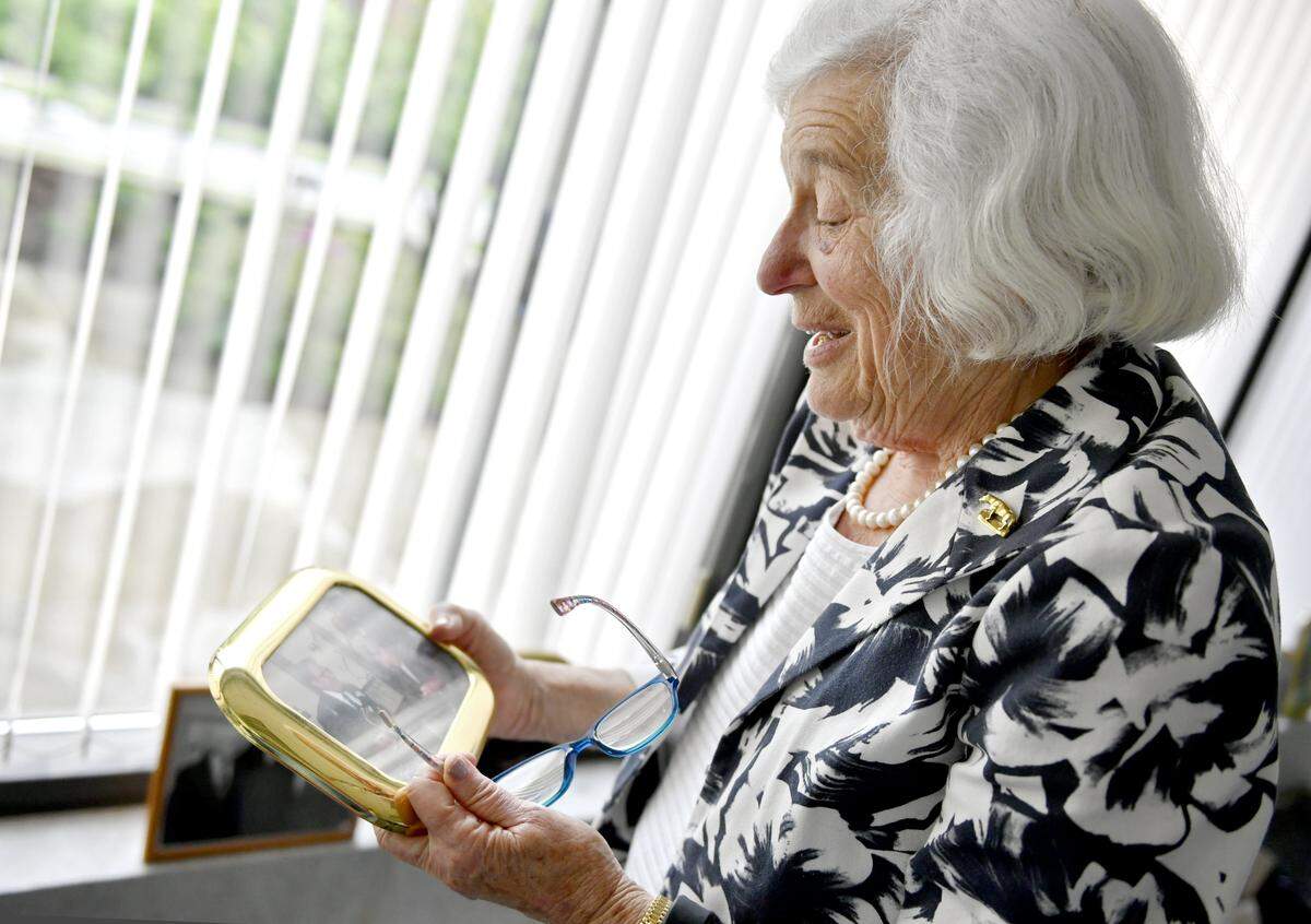Mimi Barash Coppersmith looks at one of the many photos in her office in this 2018 file photo.