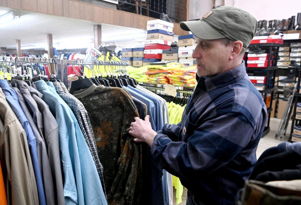 Don Rothrock shows a rack of fire retardant clothes available at Rothrocks Clothing and Shoes on Front Street in Philipsburg on Feb. 8, 2023.