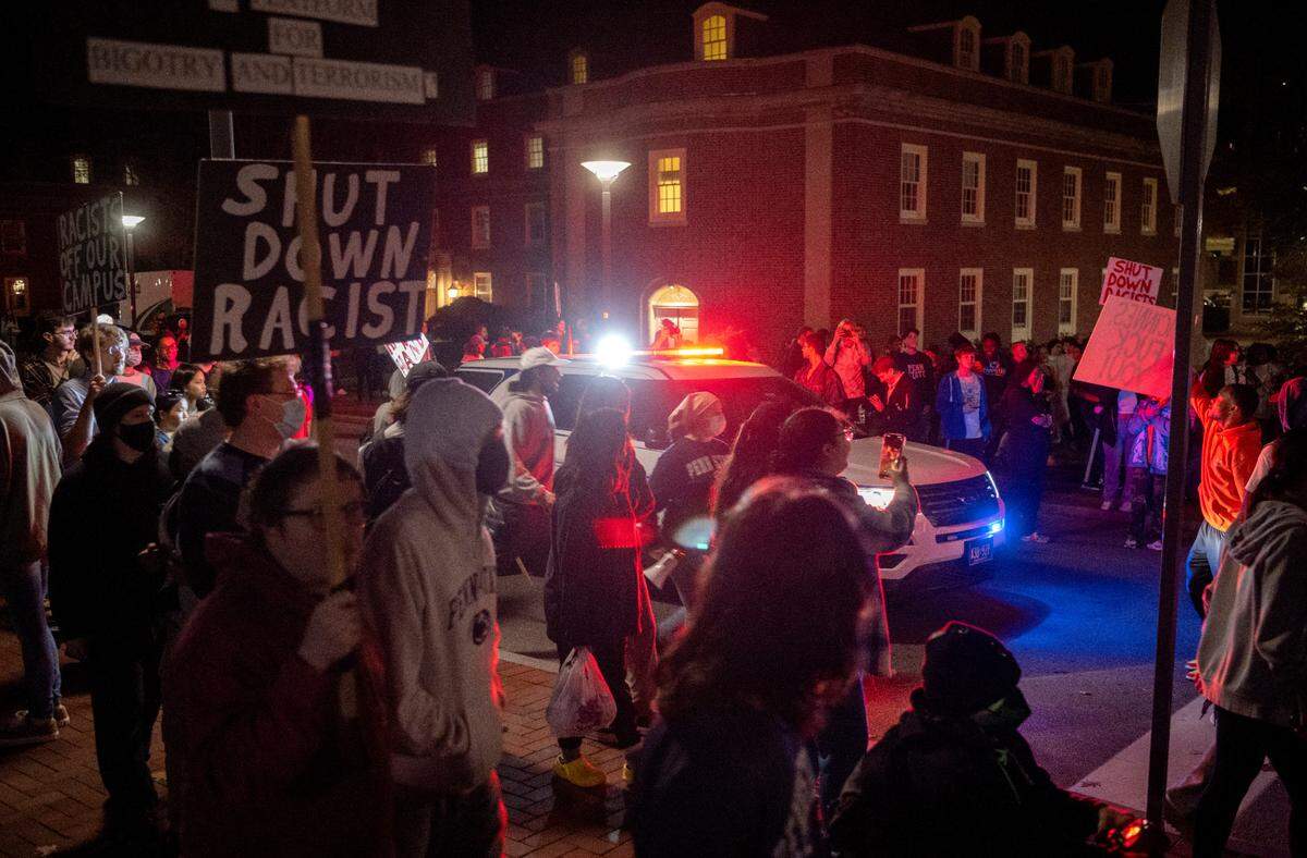 A Penn State police car drives down Pollock Road as protesters march along the road after the event “Stand Back & Stand By” was canceled on Monday, Oct. 24, 2022.