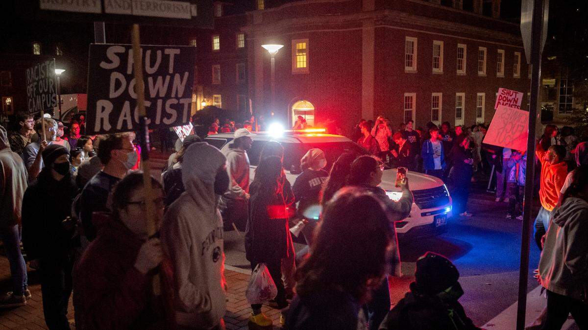 A Penn State Police car drives down Pollock Road as protesters march along the road after the event “Stand Back & Stand By” was canceled on Monday, Oct. 24, 2022.