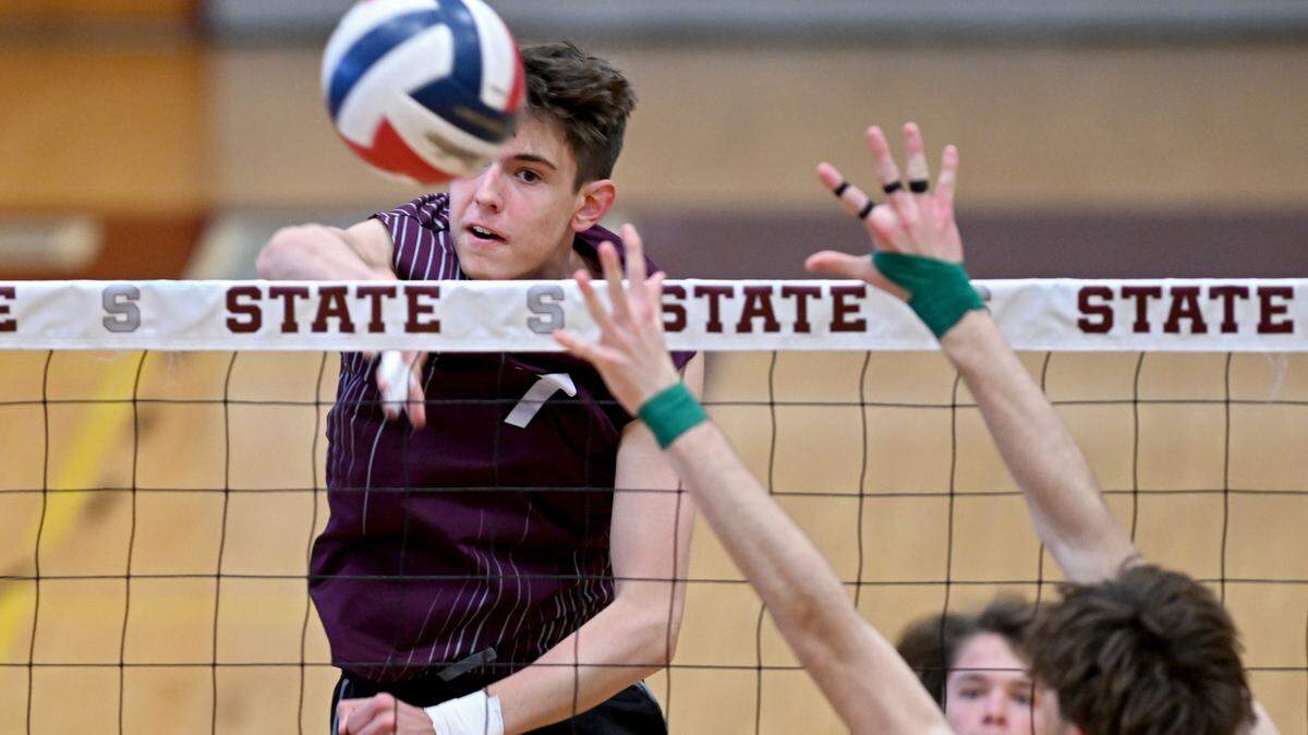 State College’s Carter Weight hits the ball past a Central Dauphin defender during the boys volleyball game on Wednesday, May 10, 2023.