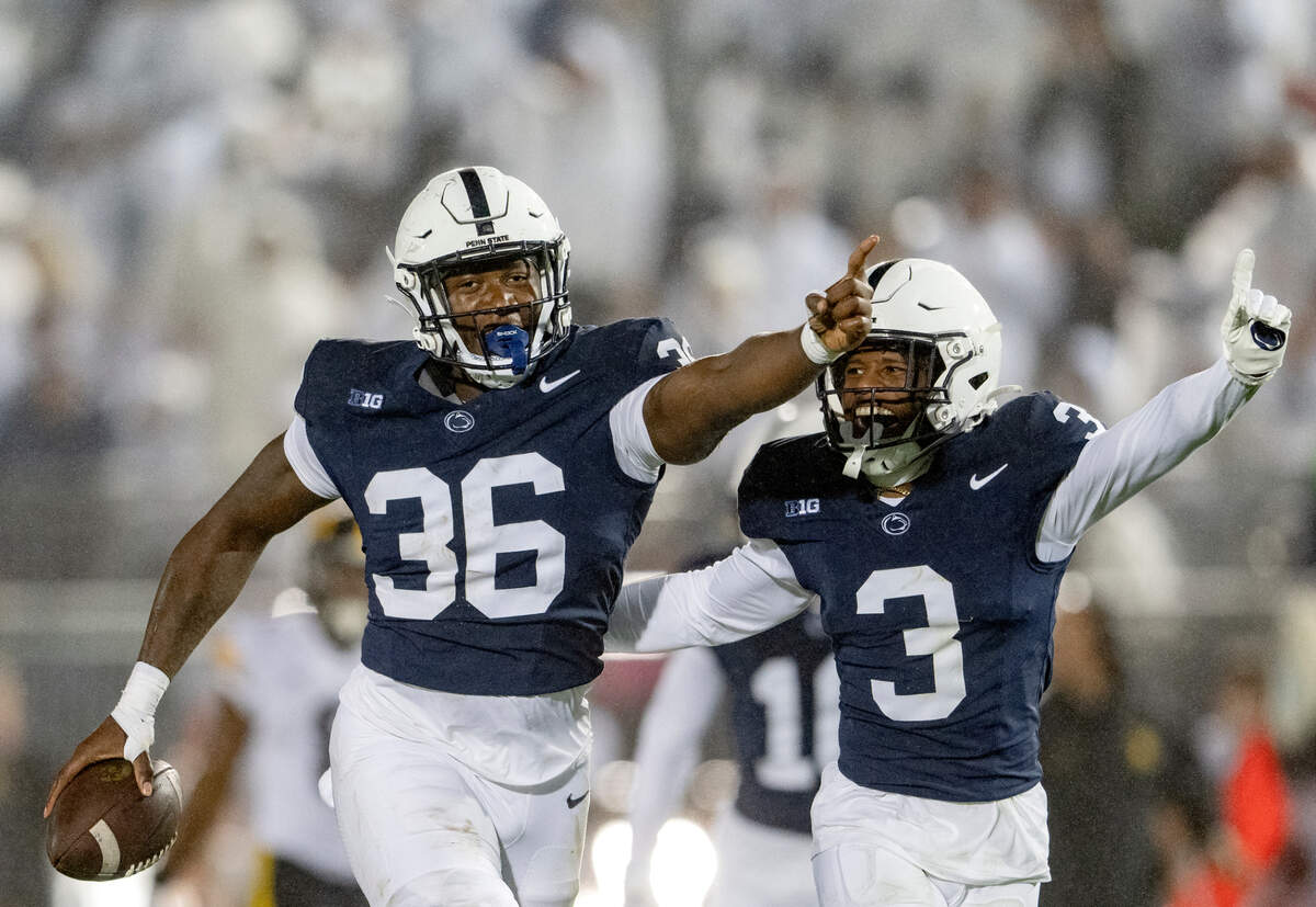 Penn State linebacker Zuriah Fisher and cornerback Johnny Dixon celebrate a play during the game against Iowa on Saturday, Sept. 23, 2023.