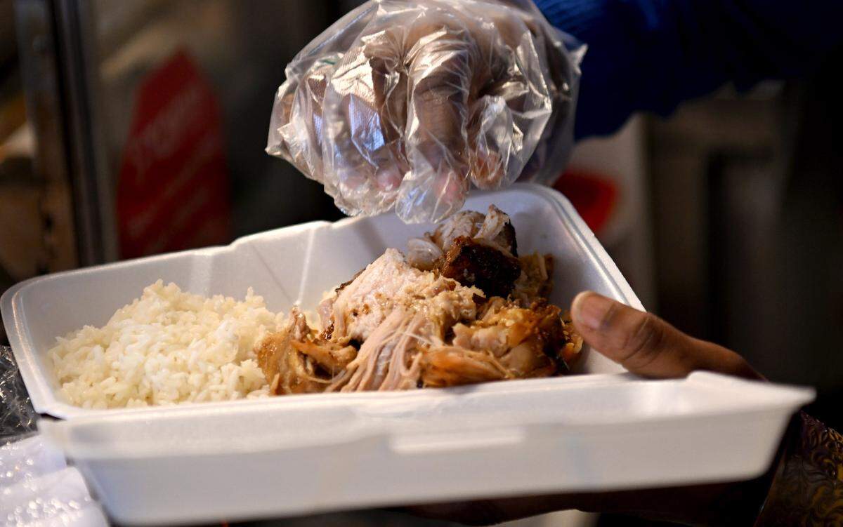 Nia Rodriguez preps an order with rice and chicharron at Coffee Hemp and Tea on Saturday, Jan. 20, 2024.