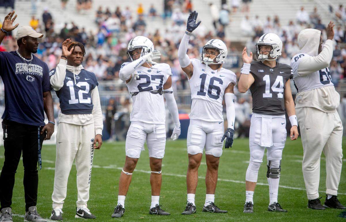 Early enrolled players including Zion Tracy, Lamont Payne Jr., Elliot Washington II and Jaxon Smolik wave to the crowd before the Penn State Blue-White game on Saturday, April 15, 2023.
