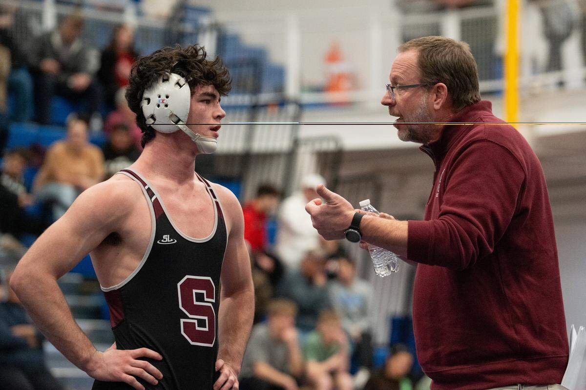 Coach Jason Nickal talks with State High's James Whitbred during the 152-pound championship bout at the Class 3A West Regional at Canon-McMillan High School in Strabane, Pa., on Saturday, Feb. 28, 2026.