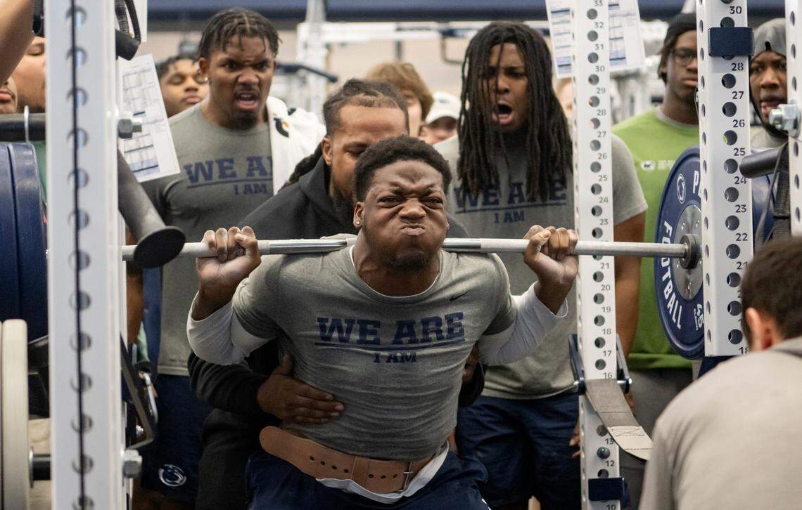 Penn State player cheer on teammate Adisa Isaac as he squats during a max-out lifting session on Thursday, March 2, 2023.