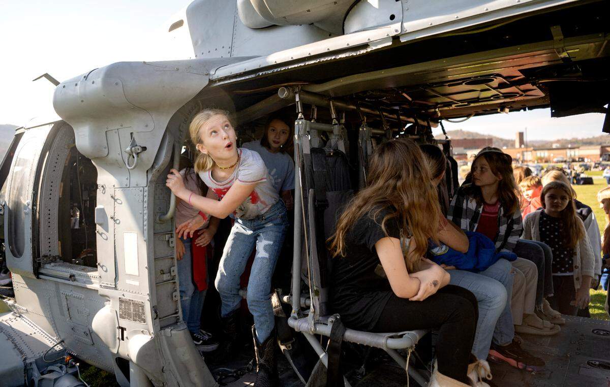 Fourth grader Laelah Shirk and her classmates check out the VX-1 Pioneers MH-60S helicopters that were flown in to the Bald Eagle Area Veterans Day celebration on Thursday, Nov. 9, 2023.