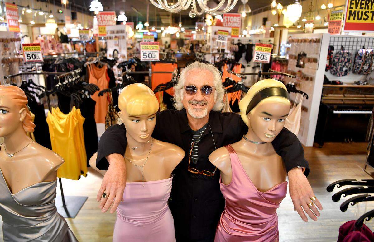 Art Fine, owner of Metro stands with two of the mannequins in the front of the store on March 13, 2020.