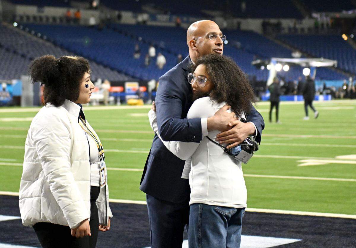 Penn State football coach James Franklin hugs his daughters before the Big Ten Championship game at Lucas Oil Stadium on Saturday, Dec. 7, 2024.  