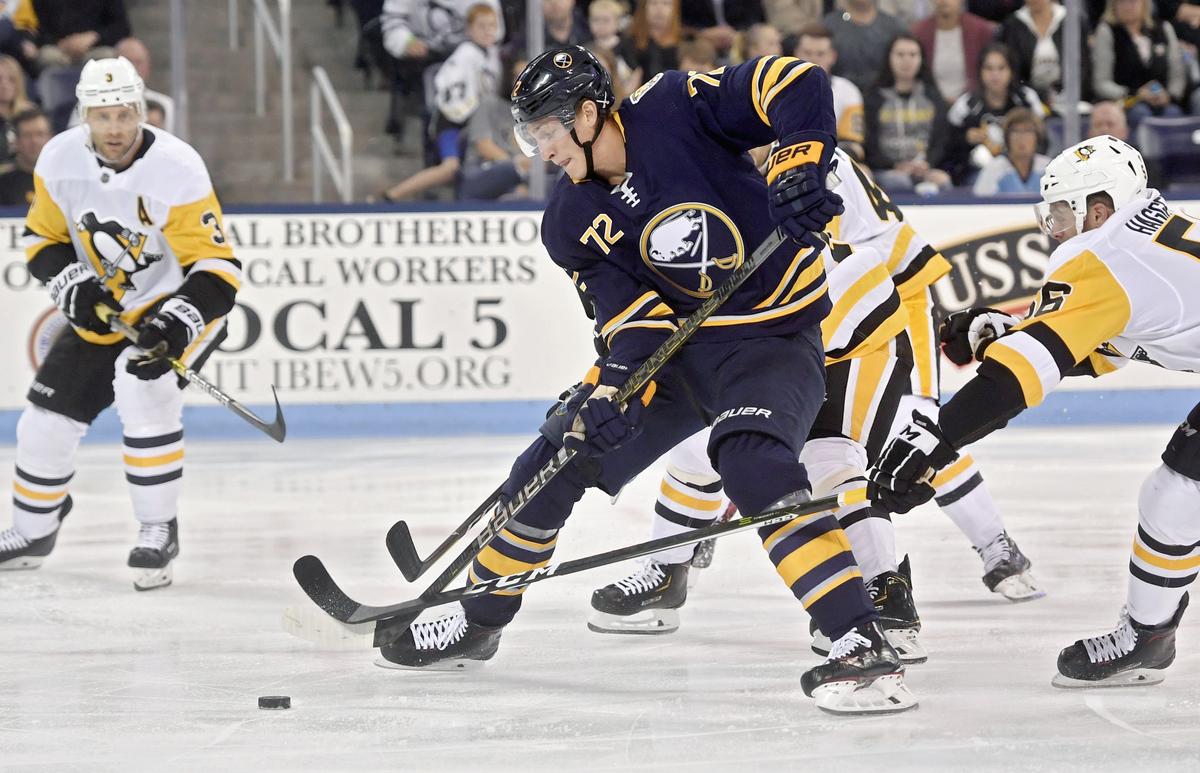 Buffalo Sabres’ Tage Thompson skates through Penguin defenders during the preseason game at Pegula Ice Arena on Monday Sept. 16, 2019.