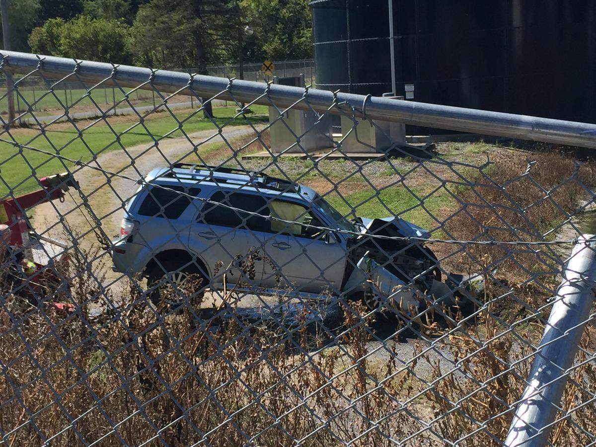 Emergency crews respond to a vehicle that crashed into a retention pond off Axemann Road in Spring Township on Wednesday.