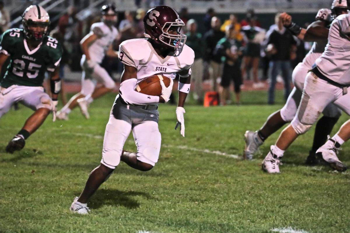 State College’s Lokey Howell runs with the ball against Carlisle on Sept. 13.