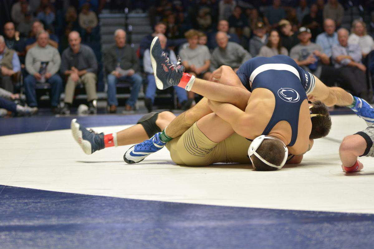 Penn State’s Luke Gardner turns Navy’s Jon Park to earn the fall in 1:46 in his Rec Hall debut on Sunday. Penn State won its season opener 45-0.