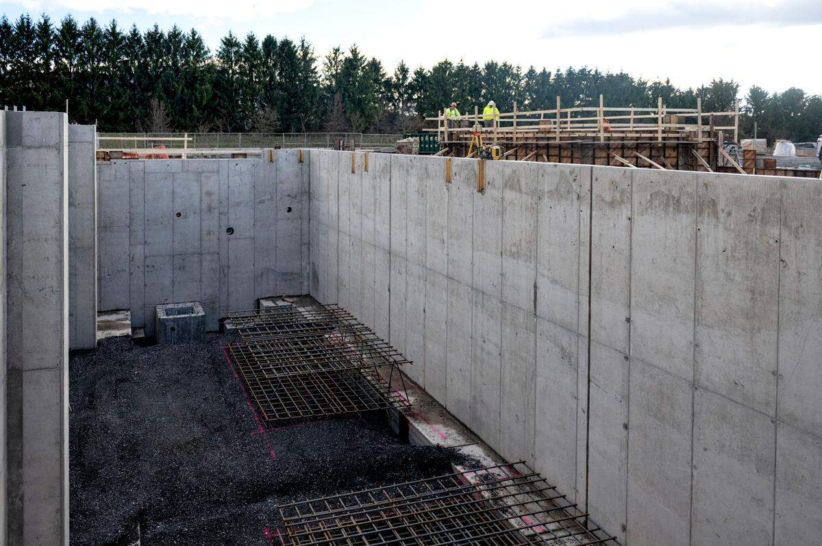 Construction crews work on Nov. 26 at the waste receiving building that is part of the biosolids project at the University Area Joint Authority.