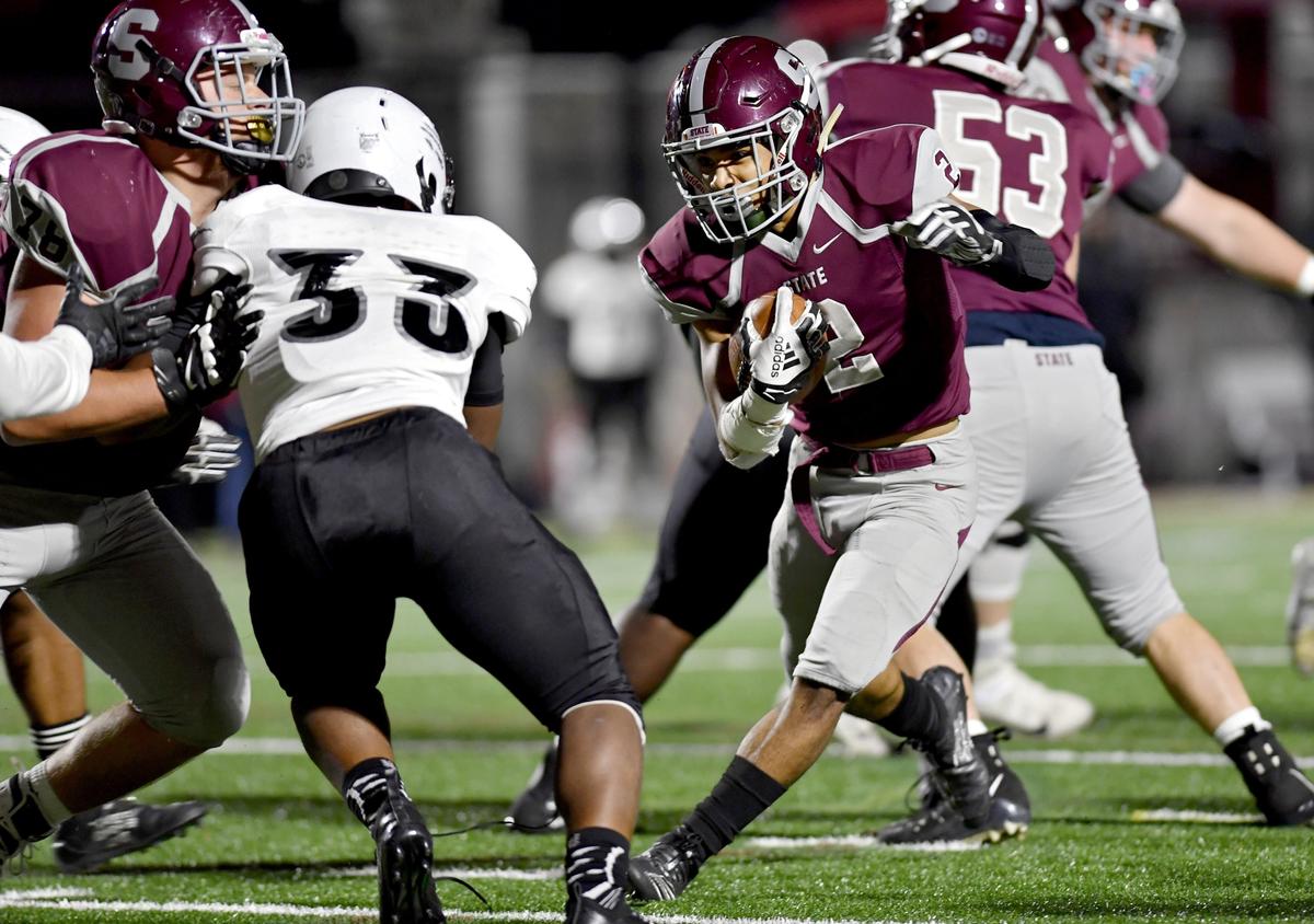 State College’s Dresyn Green cuts down the field with the ball from Harrisburg defenders during the game on Friday, Oct. 4, 2019.