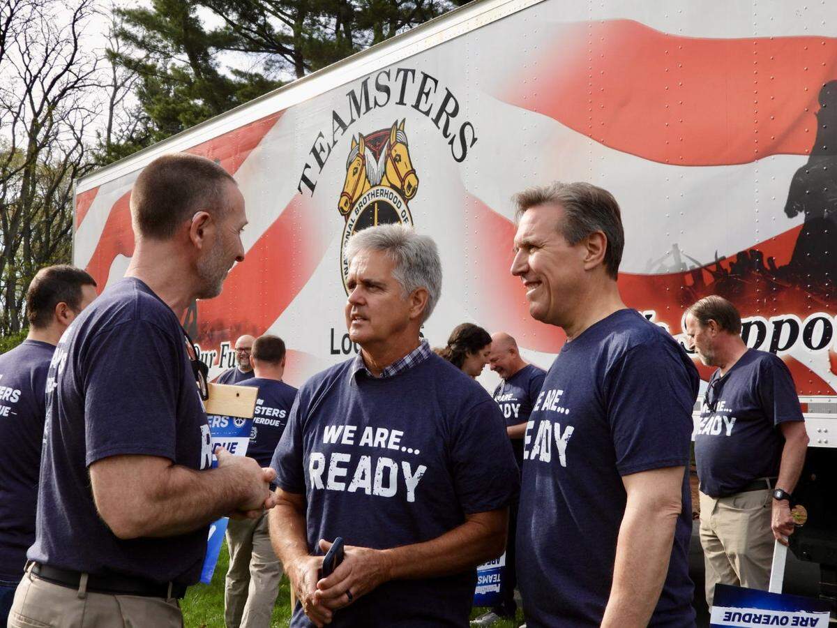 Teamsters Local Union 8 President Jon Light (left) talks with state house representatives Scott Conklin (center) and Paul Takac during a rally before they began negotiations with Penn State on May 2.