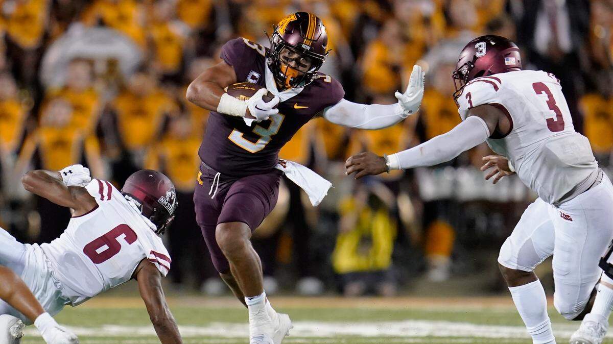 Minnesota running back Trey Potts carries the ball between New Mexico State linebacker Chris Ojoh, right, and defensive back Syrus Dumas, left, during the first half of a game Sept. 1, 2022, in Minneapolis. Potts is from Williamsport.
