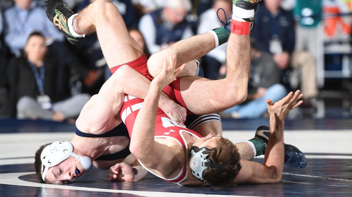 Penn State’s Nick Lee, 141 lbs (right) takes down Wisconsin’s Tristan Moran Sunday at Rec. Hall. Moran edged Lee, 12-10. Penn State defeated Wisconsin 24-13. (For the CDT/Steve Manuel)
