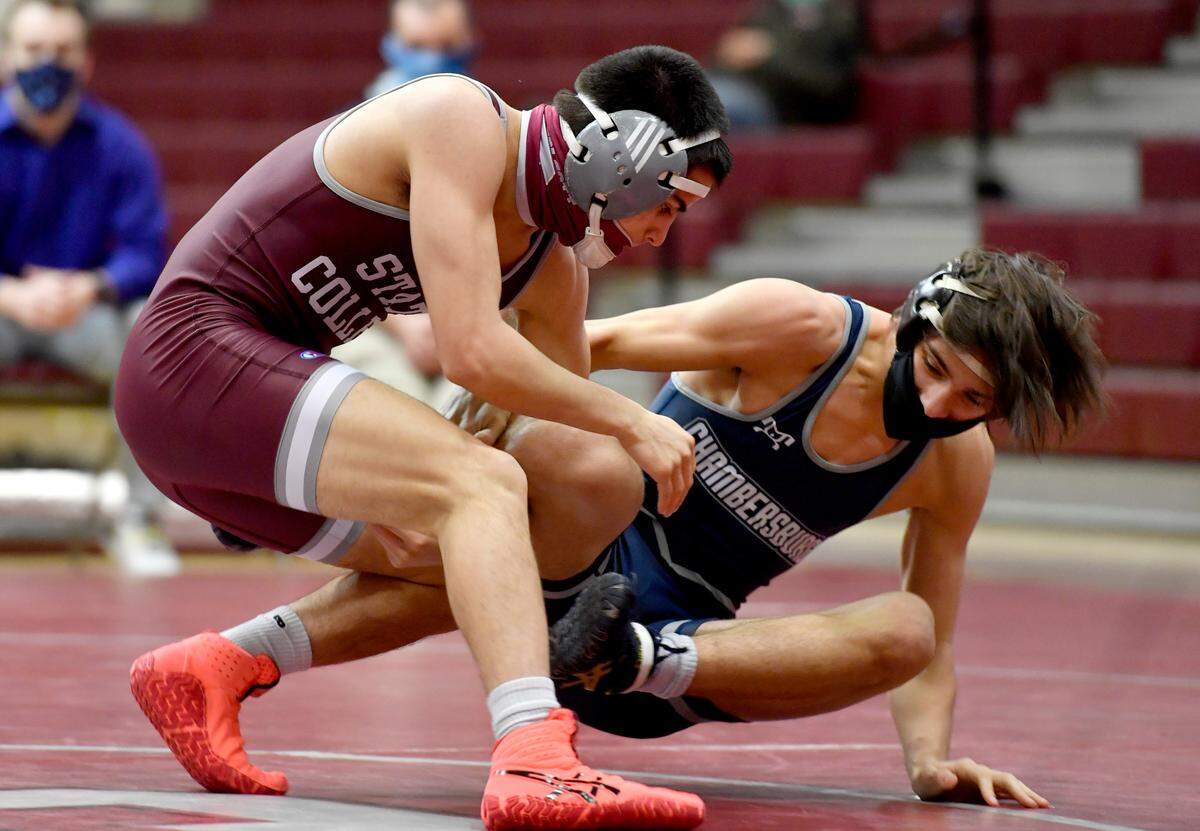State College’s Owen Woolcott goes after Chambersburg’s Luke Mentzer in the 126 lb bout during the match on Monday, Feb. 8, 2021. Woolcott won by tech fall, giving him his 100th career win.