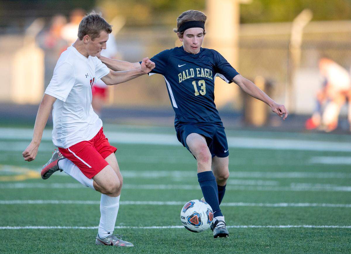 Bellefonte's Ben Hargrove and Bald Eagle Area's Parker Quick fight for the ball during the game on Wednesday, Sept. 29, 2021.  