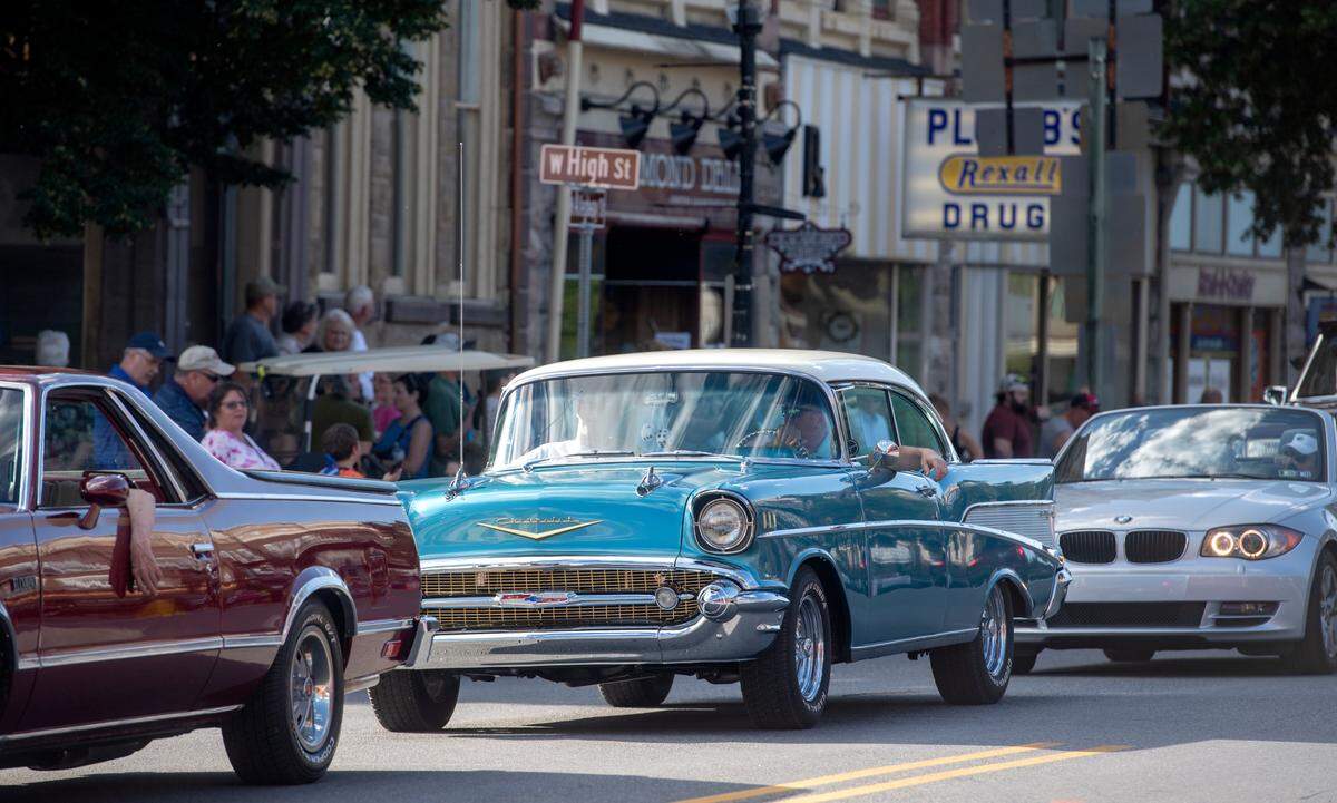A classic Chevrolet cruises Allegheny Street as people line the sidewalks for the Bellefonte Cruise on Friday, June 17, 2022.