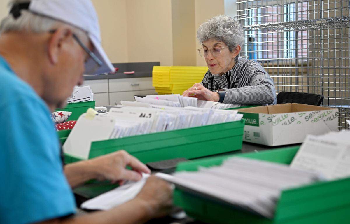 Laura Brown and fellow election office volunteers sort the mail in ballots at the Willowbank Building on Monday, May 15, 2023.