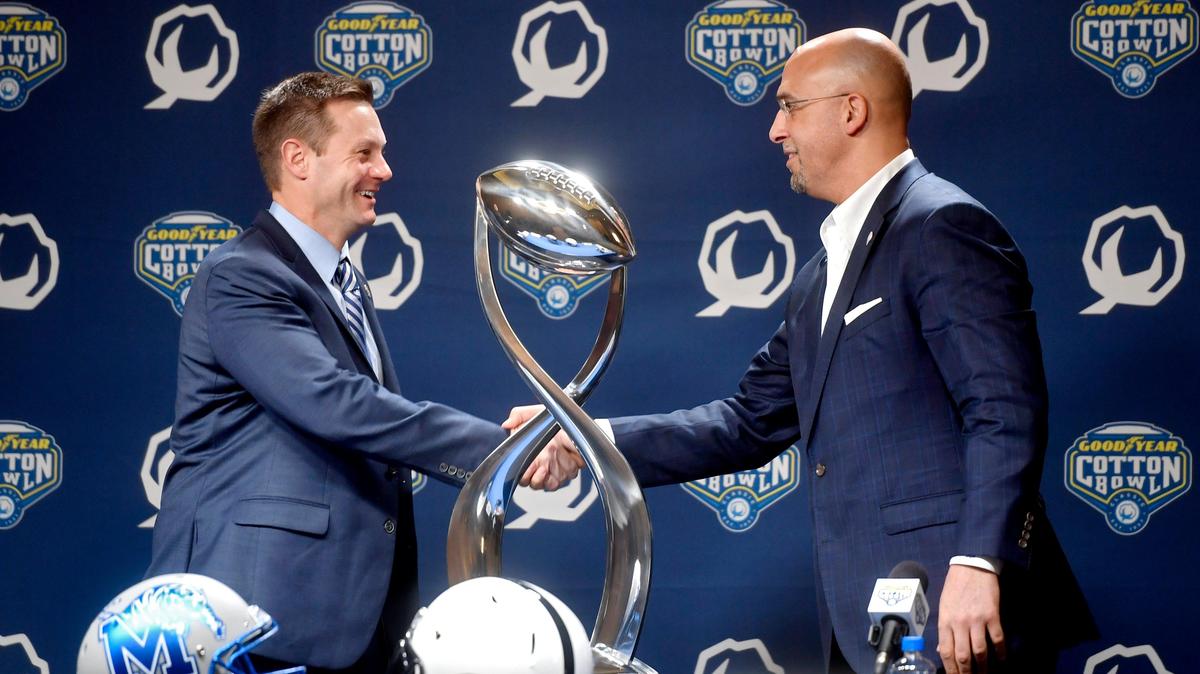 Memphis coach Ryan Silverfield and Penn State coach James Franklin shake hands next to the Cotton Bowl trophy during a press conference on Friday, Dec. 27, 2019.