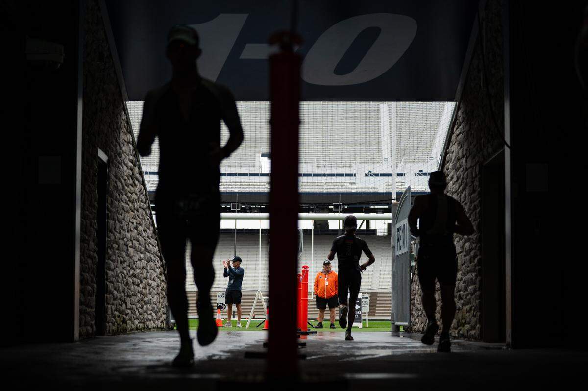 Athletes run through the tunnel in Beaver Stadium during the third leg of the Ironman 70.3 Happy Valley on Sunday, June 15, 2025 in University Park, Pa.
