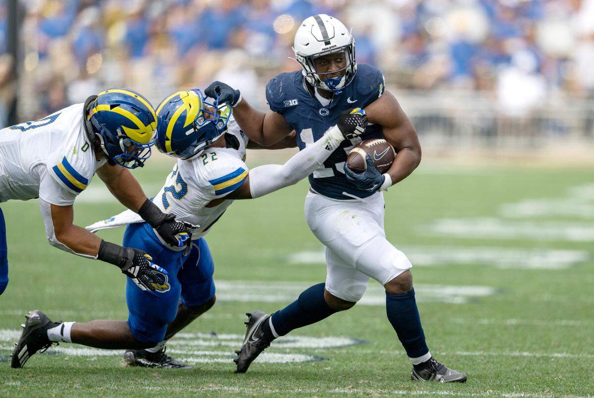 Delaware’s Nic Ware tries to stop Penn State running back Kaytron Allen during the game on Saturday, Sept. 9, 2023.