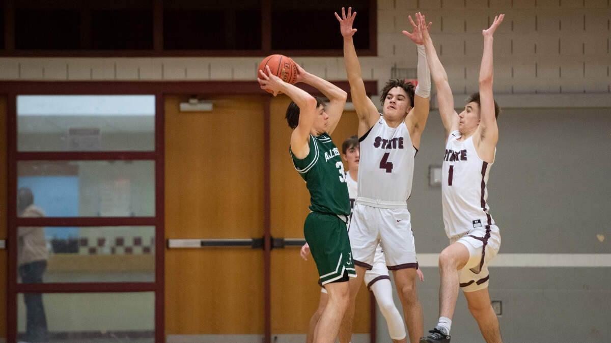 Braeden Shrewsberry (4) and Jaden Mitchell (1) defend during a PIAA high school basketball game between State College High School and Taylor Allderdice High School on Friday.