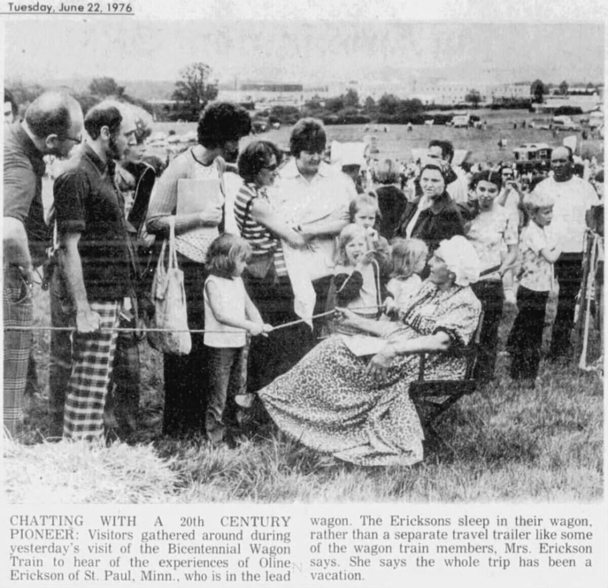 A large crowd gathered around representatives traveling alongside the Bicentennial Wagon Train when it passed through Centre County in June 1976. This photograph, published in the Centre Daily Times on June 22, 1976, shows visitors speaking with a wagon train passenger at an encampment near Beaver Stadium.