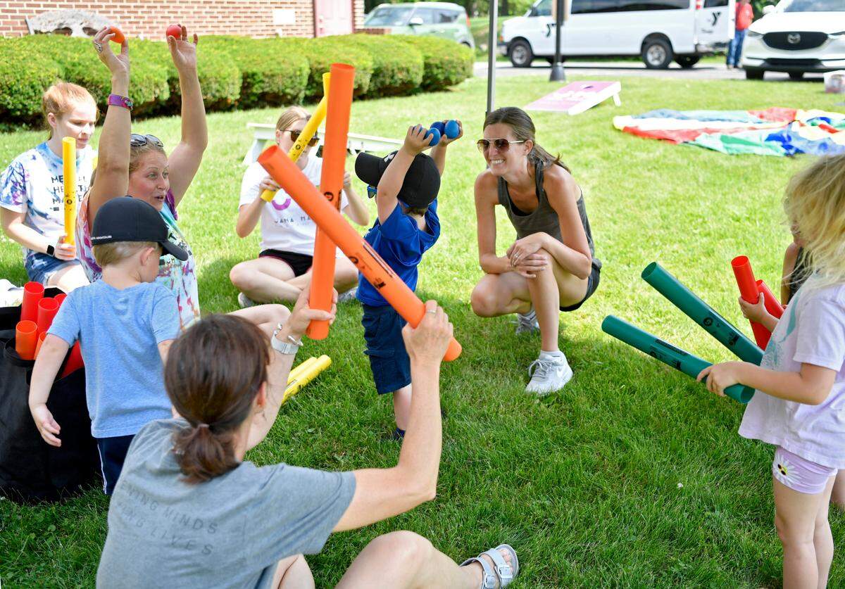 A group gathers to sing and make music outside of Trinity UCC in Centre Hall on Monday during a stop on the Free to be Me tour from the YMCA of Centre County and Jana Marie Foundation.