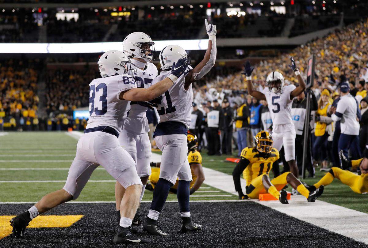 Penn State running back Noah Cain, center, celebrates his touchdown during the second half of the team’s NCAA college football game against Iowa on Saturday, Oct. 12, 2019, in Iowa City, Iowa. (AP Photo/Matthew Putney)