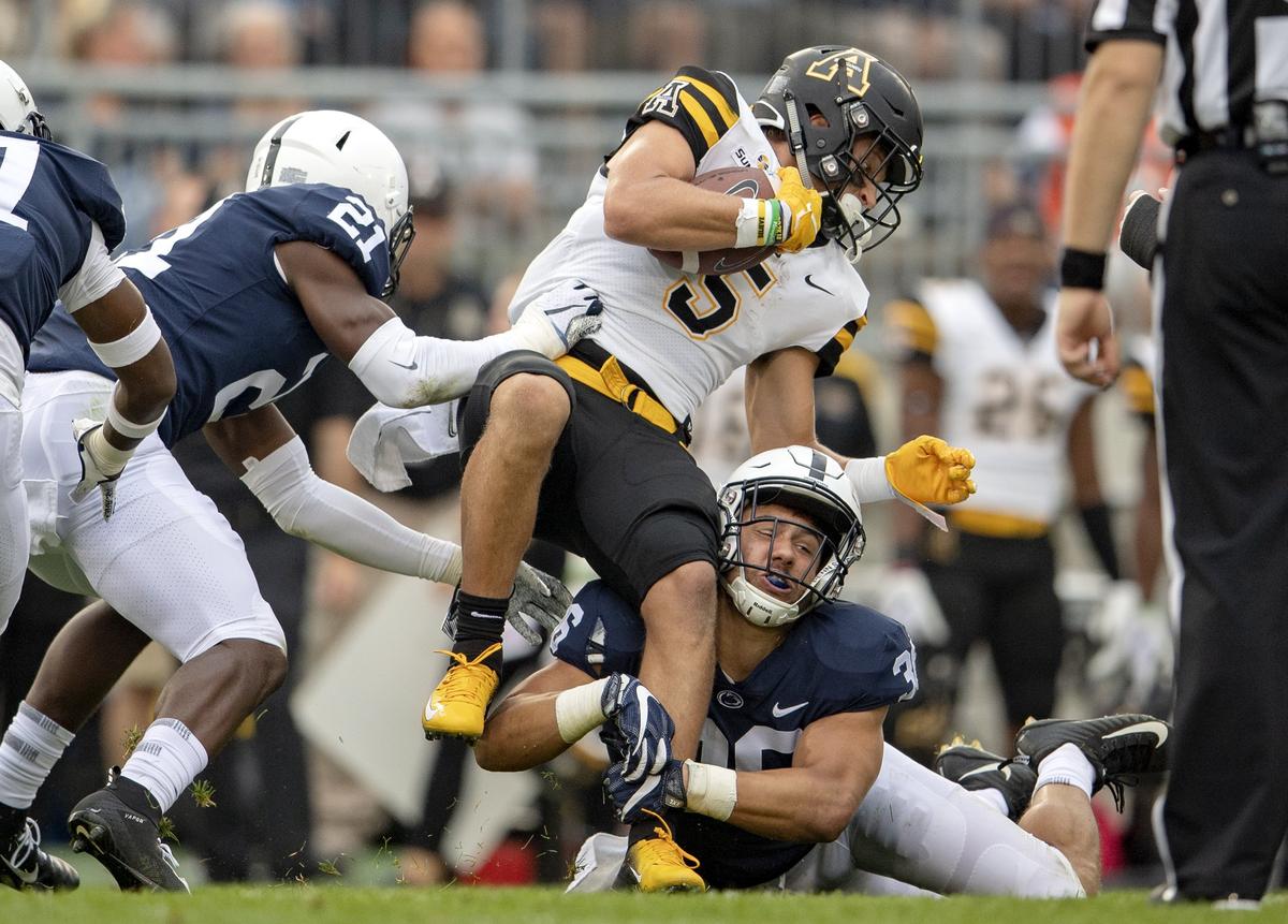 Penn State linebacker Jan Johnson trips up Appalachian State wide receiver Thomas Hennigan during the Saturday, Sept. 1, 2018 game at Beaver Stadium.