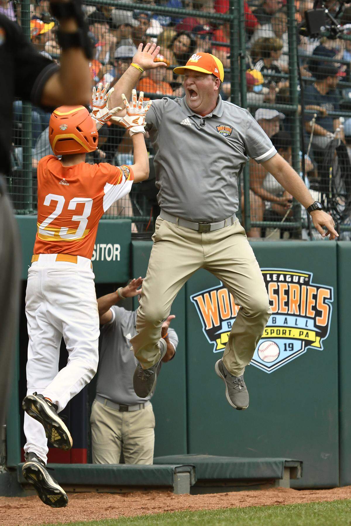 River Ridge, Louisiana’s Marshall Louque (23) celebrates with manager Scott Frazier after scoring against Wailuku, Hawaii in the sixth inning of the United States Championship baseball game at the Little League World Series tournament in South Williamsport on Aug. 24, 2019. River Ridge, Louisiana won the game 9-5.