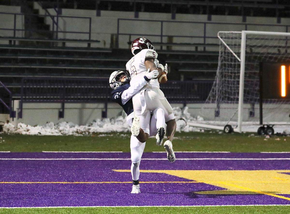 State College’s Isaiah Edwards hauls in a touchdown pass on Friday against McDowell in the PIAA Class 6A subregional football game at Erie Veterans Memorial Stadium. State College won 42-21.
