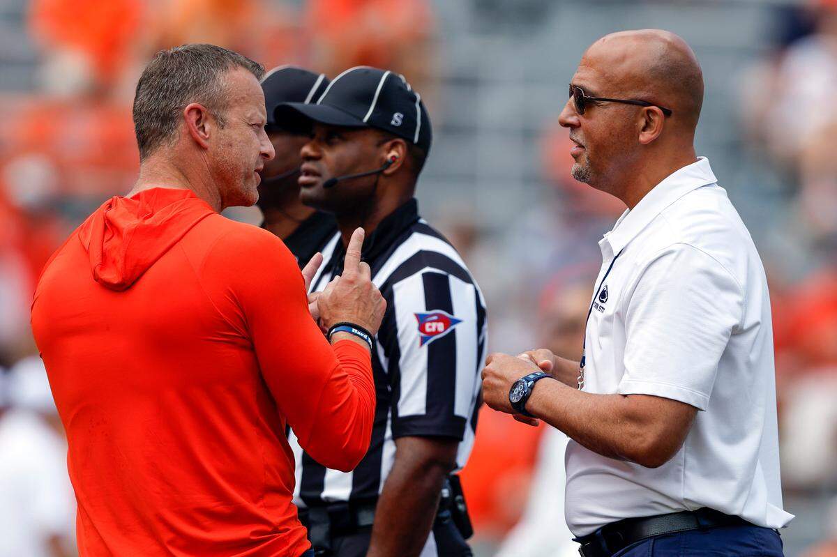 Auburn head coach Bryan Harsin, left, talks with Penn State head coach James Franklin, right, before an NCAA college football game Saturday, Sept. 17, 2022, in Auburn, Ala. (AP Photo/Butch Dill)