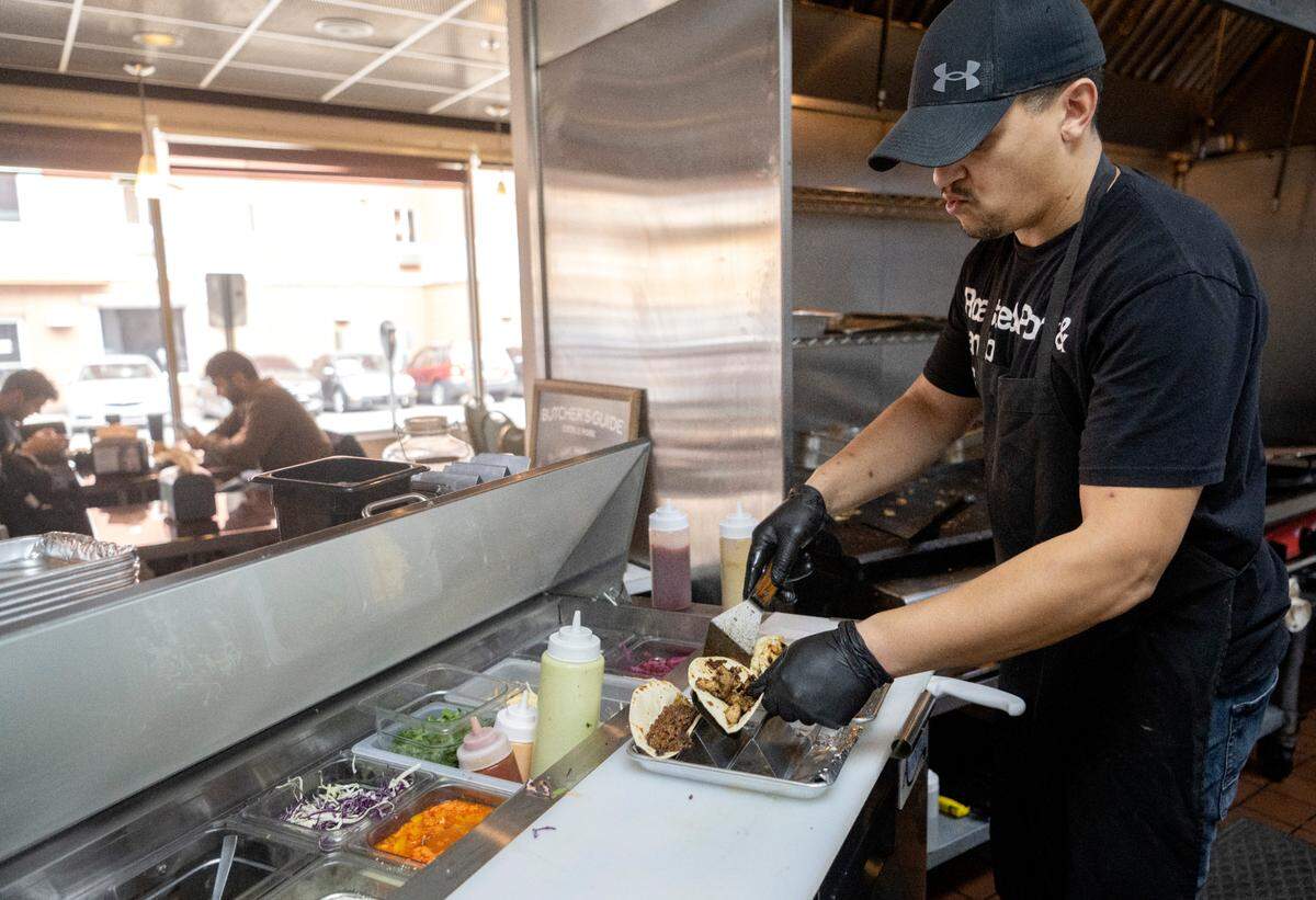 Shawn Carter makes an order of tacos at Carter’s Table on March 22, 2023.