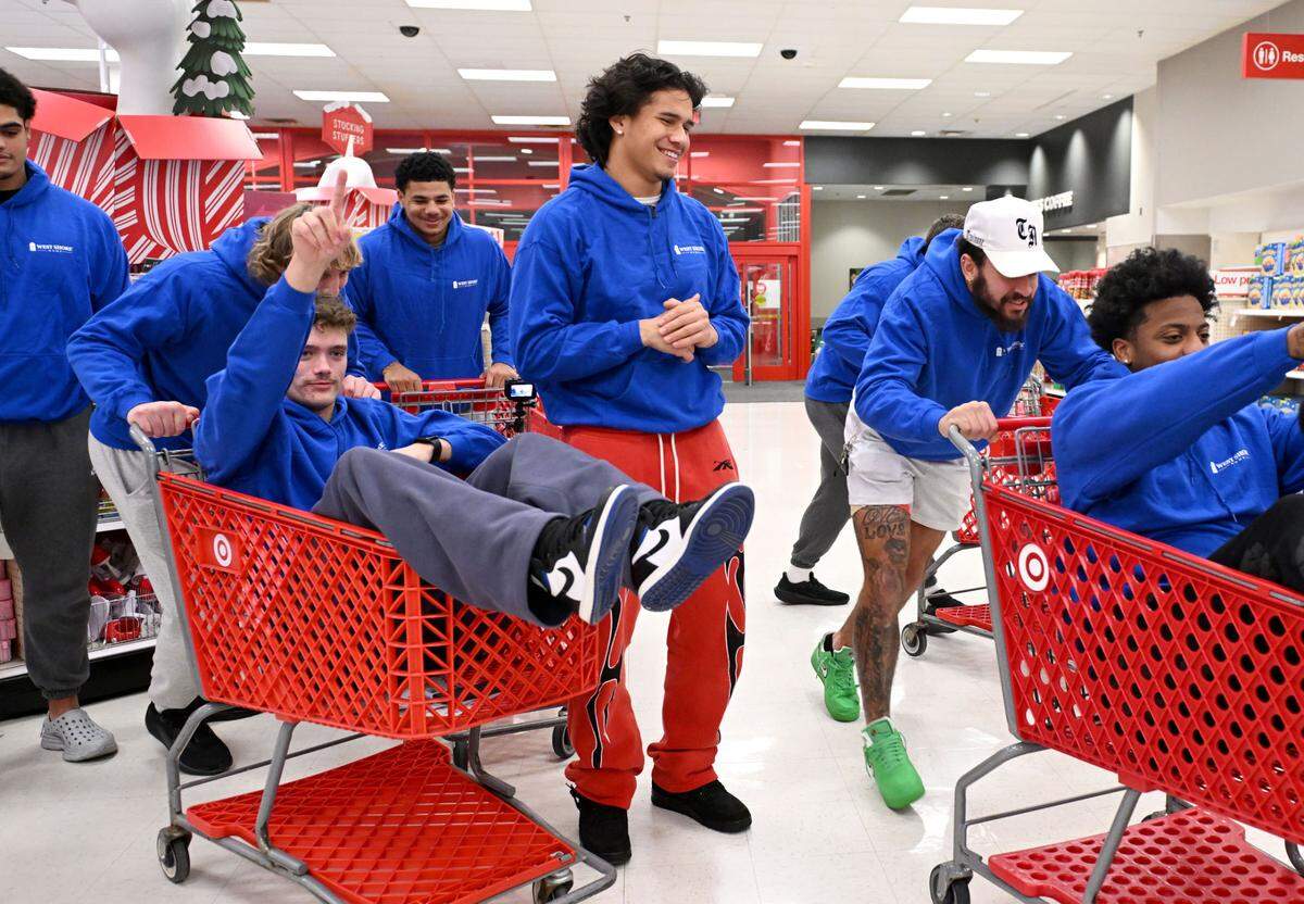 Tony Rojas laughs as he and his Penn State football teammates help West Shore Home shop for Toys for Tots at Target in State College on Monday, Dec. 2, 2024.