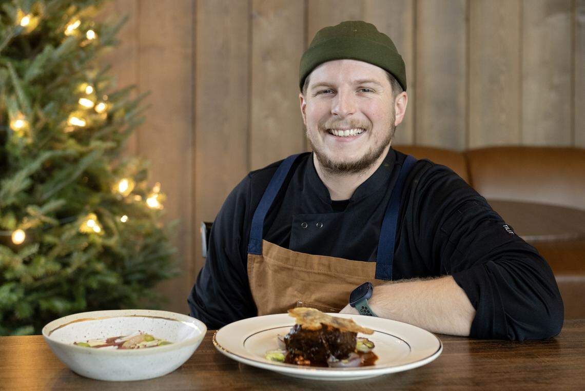 Chef Derek Polay poses with a yellow tail tuna dish and braised short rib dish at the Studebaker House on Wednesday, Dec. 10, 2025. 