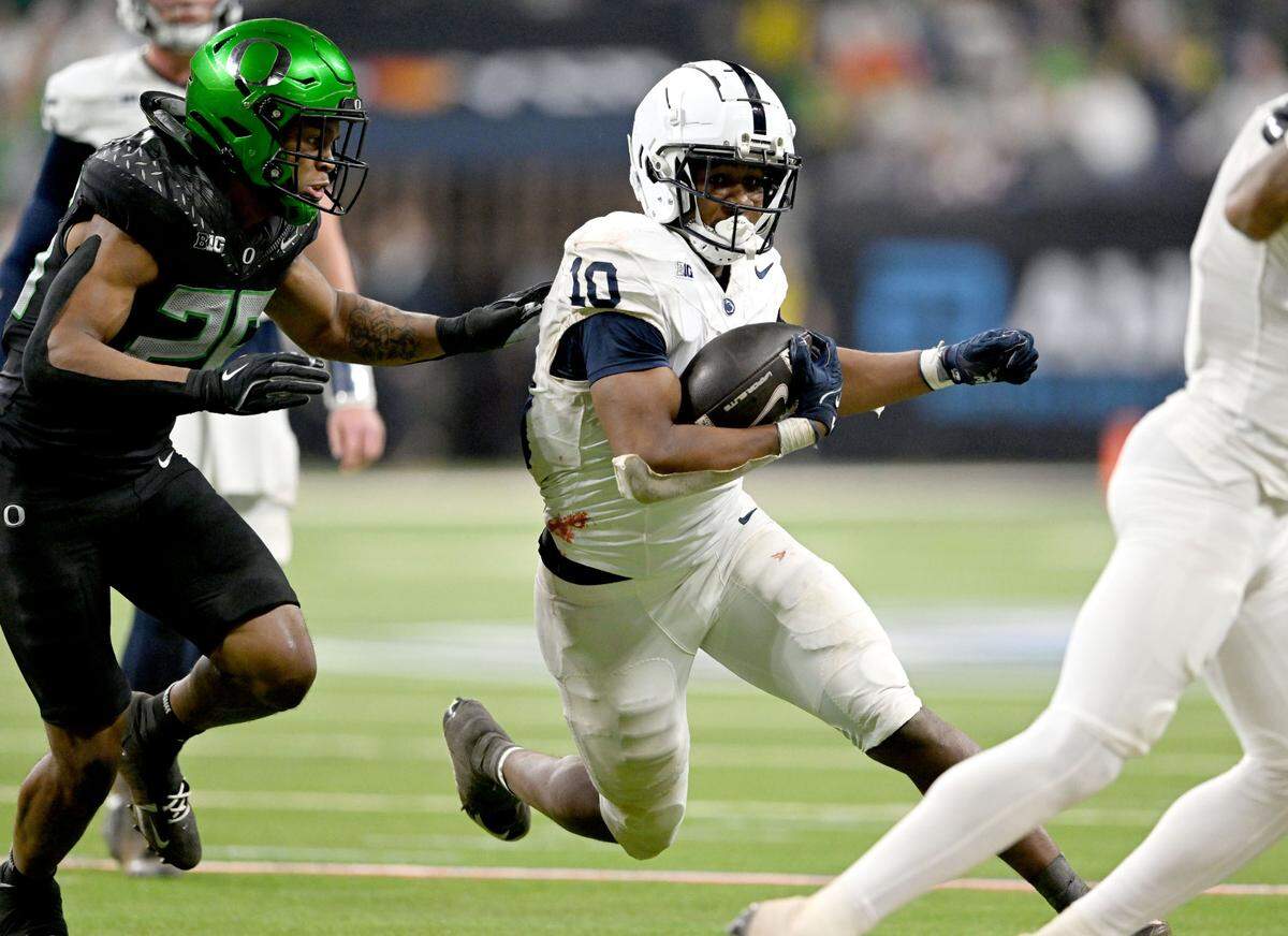 Penn State running back Nick Singleton cuts down the field with the ball from an Oregon defender during the Big Ten Championship game at Lucas Oil Stadium on Saturday, Dec. 7, 2024.