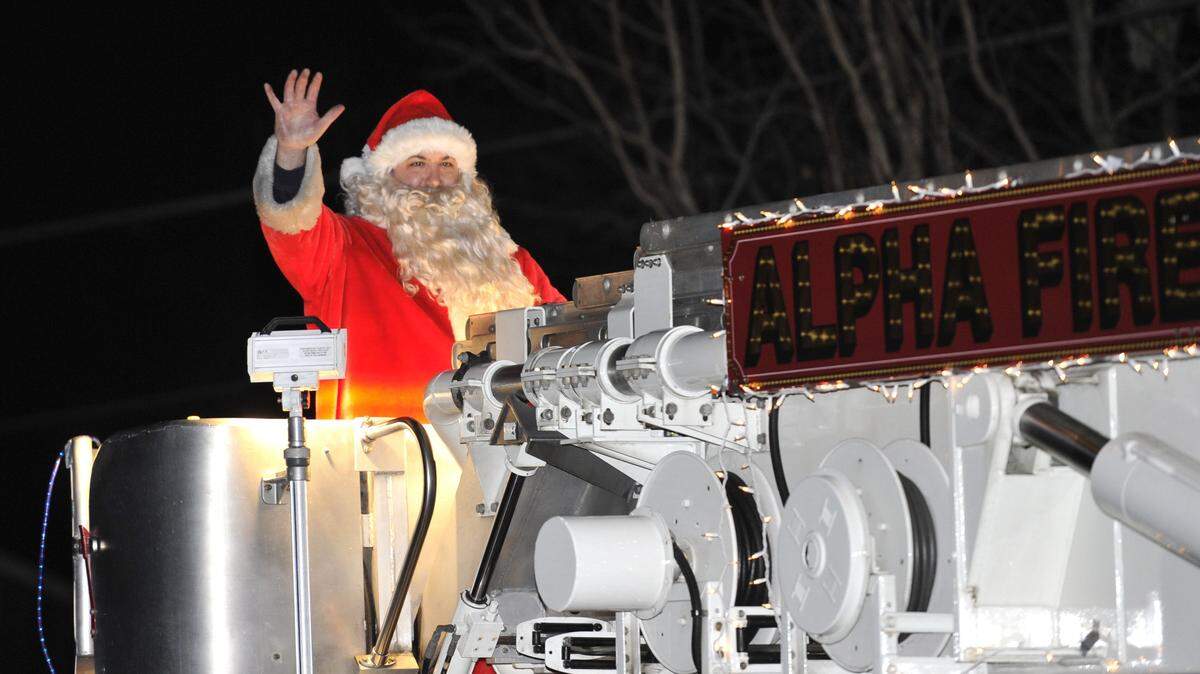Santa Claus rides an Alpha Fire Company truck through the Park Hills neighborhood in State College, Pa. as part of “The Santa Run” on Christmas Eve in 2015.